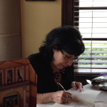 Cynthia signing books.